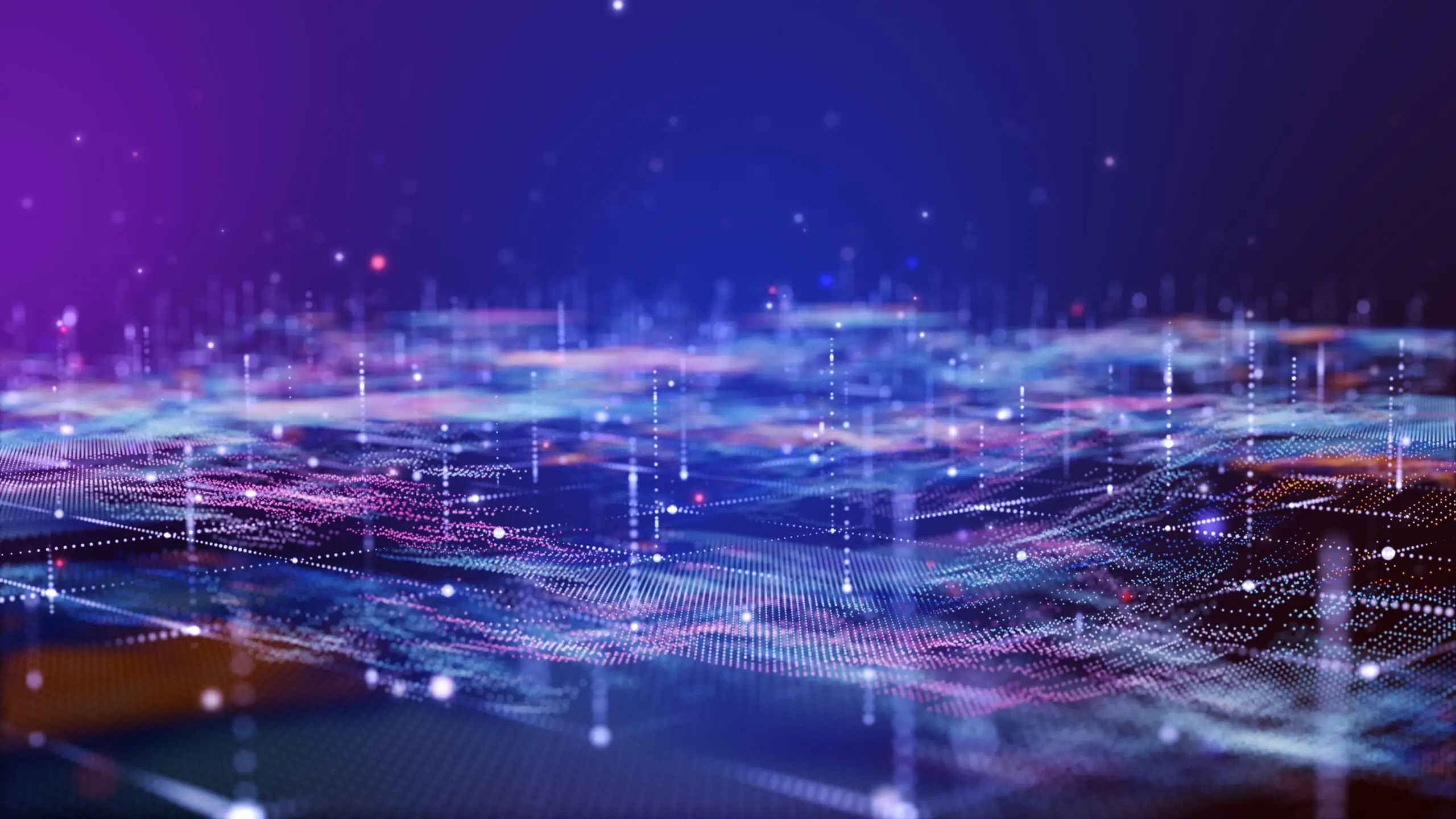 An abstract digital landscape composed of glowing purple, blue, and pink particle nodes and data networks with shallow depth of field.