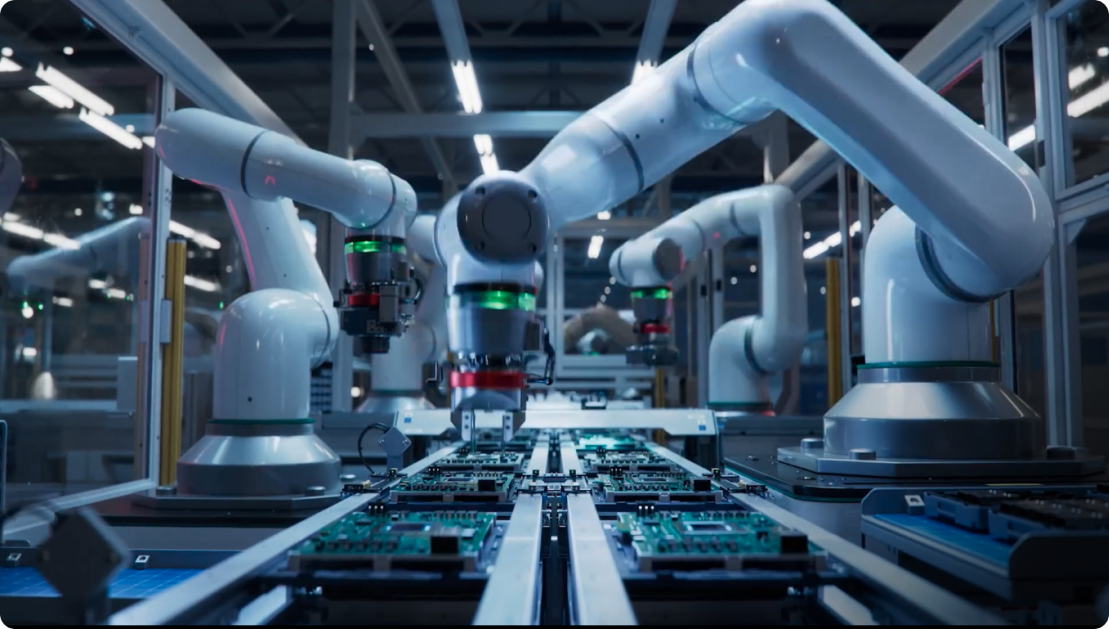 Robotic arms assembling green circuit boards along a modern automated factory conveyor line.