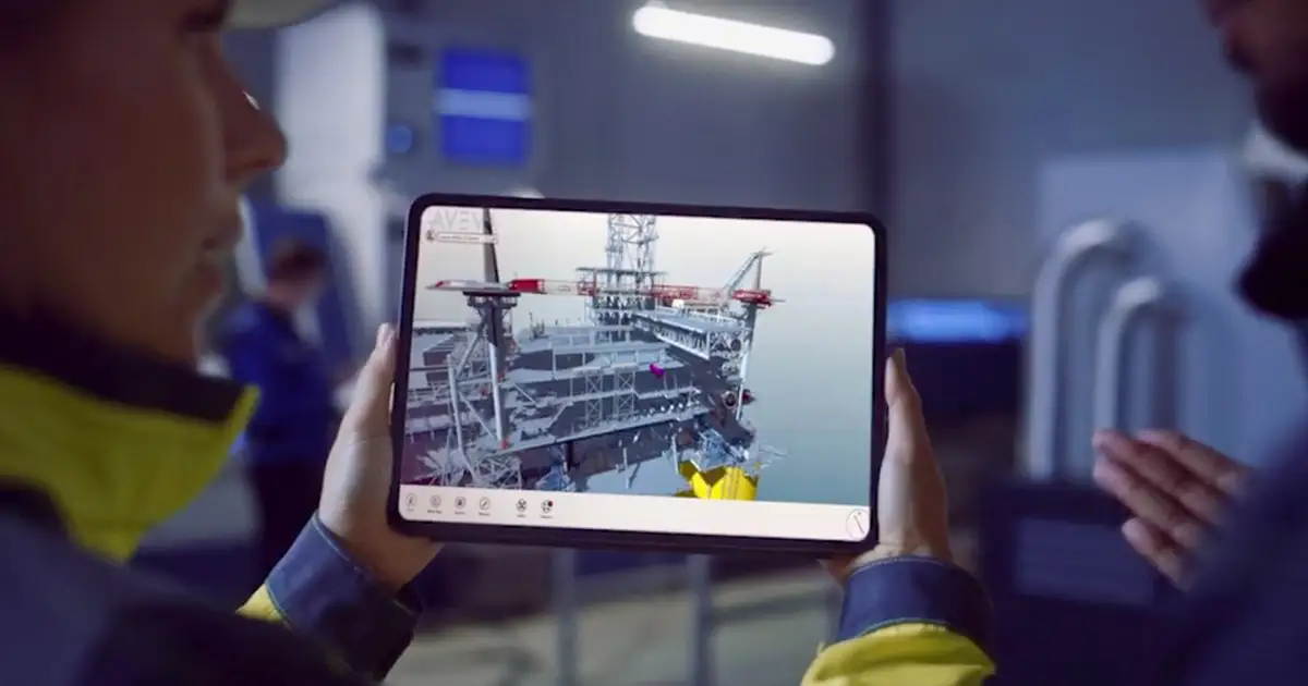 two people looking at engineering plans on a tablet